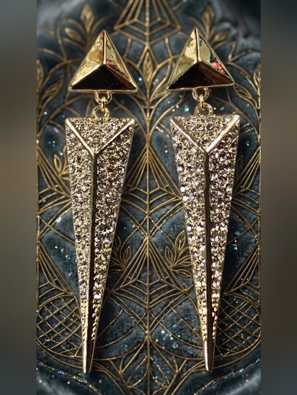 Gold dangle earrings with a unique triangle design. Clear pave crystals.